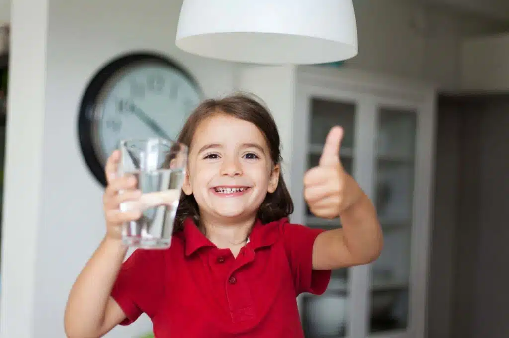 Girl happy to have a clean and purified drinking water